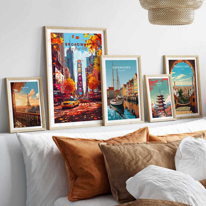 Collection of travel prints featuring Broadway, Copenhagen, and Barcelona displayed in a cozy living room setting.