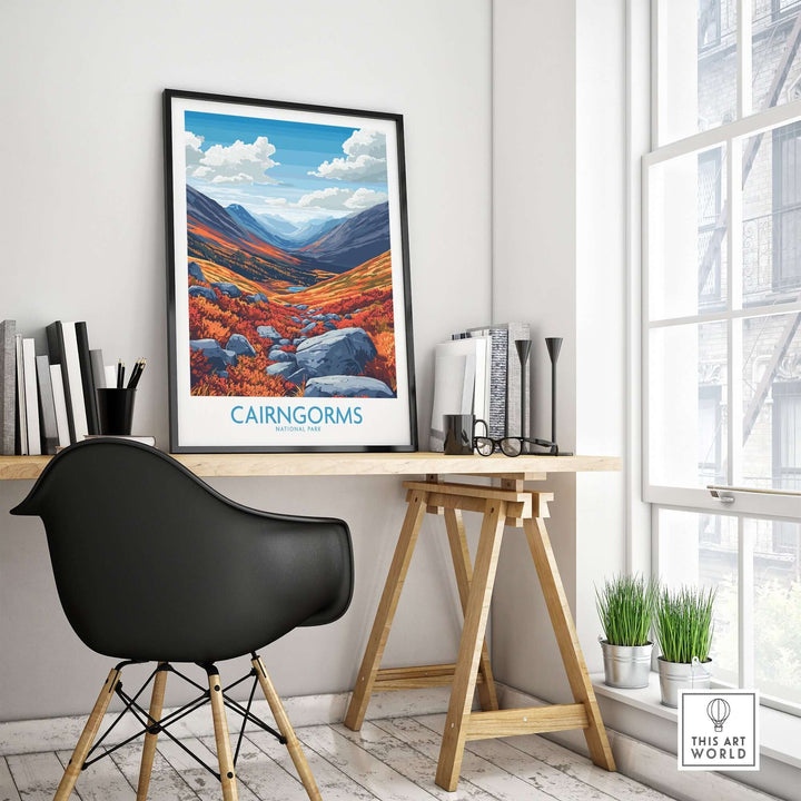 Cairngorms art print displayed on a desk in a modern workspace, showcasing vibrant landscape colors and mountain scenery.