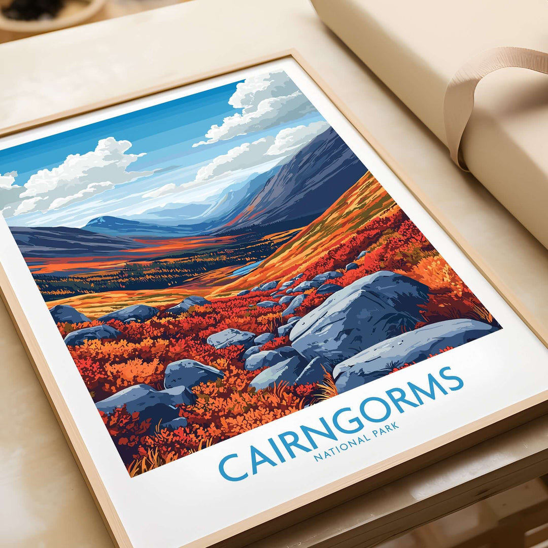 Cairngorms Art Print featuring vibrant autumn landscape with mountains and rocks, framed on a wooden table.