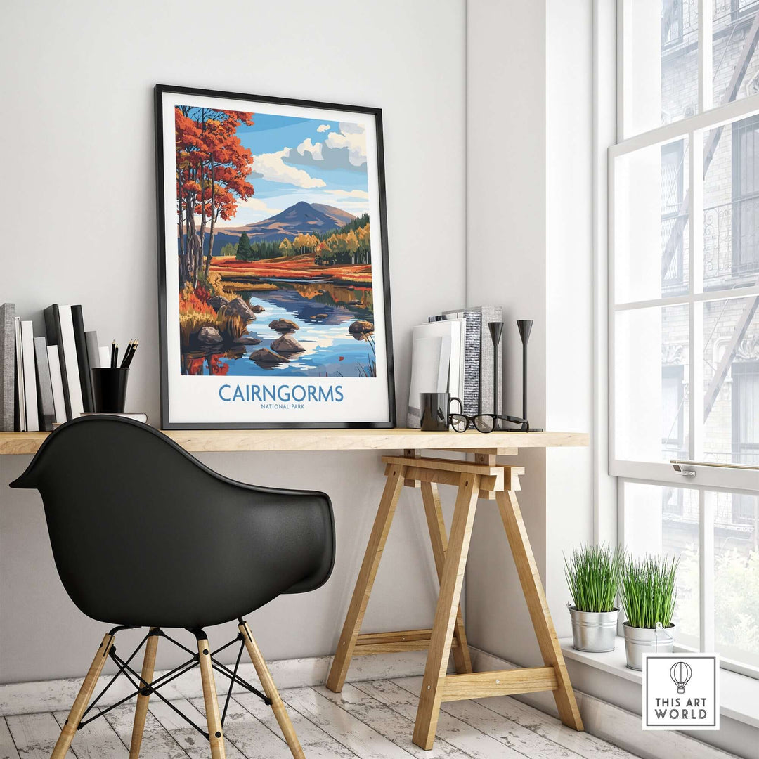 Cairngorms National Park wall art print displayed in a modern workspace with a black chair and wooden table.