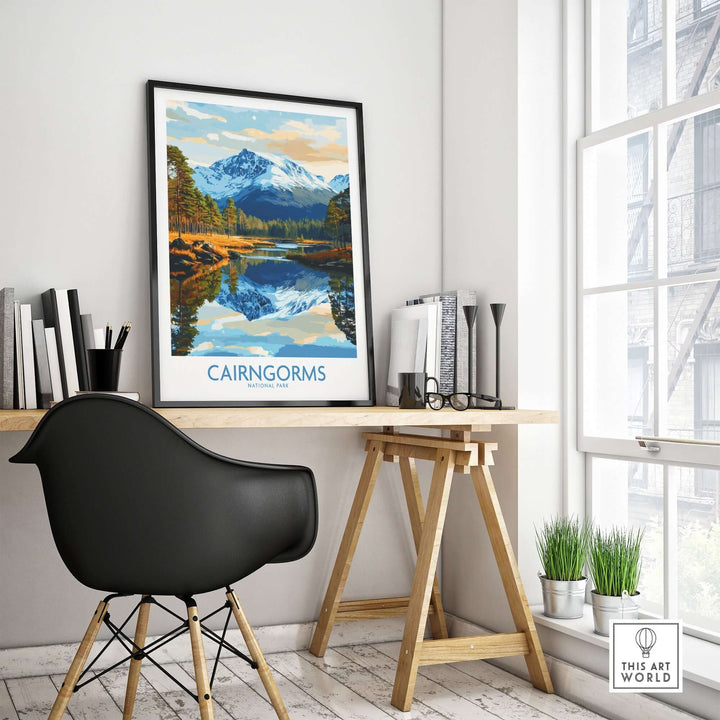 Cairngorms National Park poster displayed in a modern workspace, showcasing scenic mountain reflection.