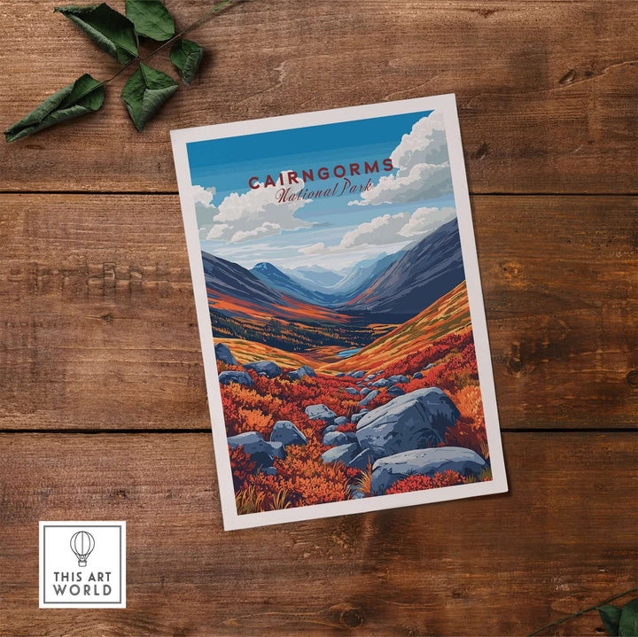 Cairngorms National Park print featuring vibrant landscapes and mountains, displayed on a wooden surface.