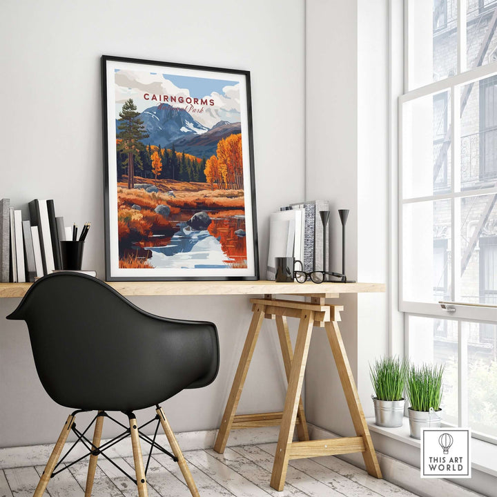 Cairngorms travel print framed on a wall above a stylish desk in a bright room with modern decor.