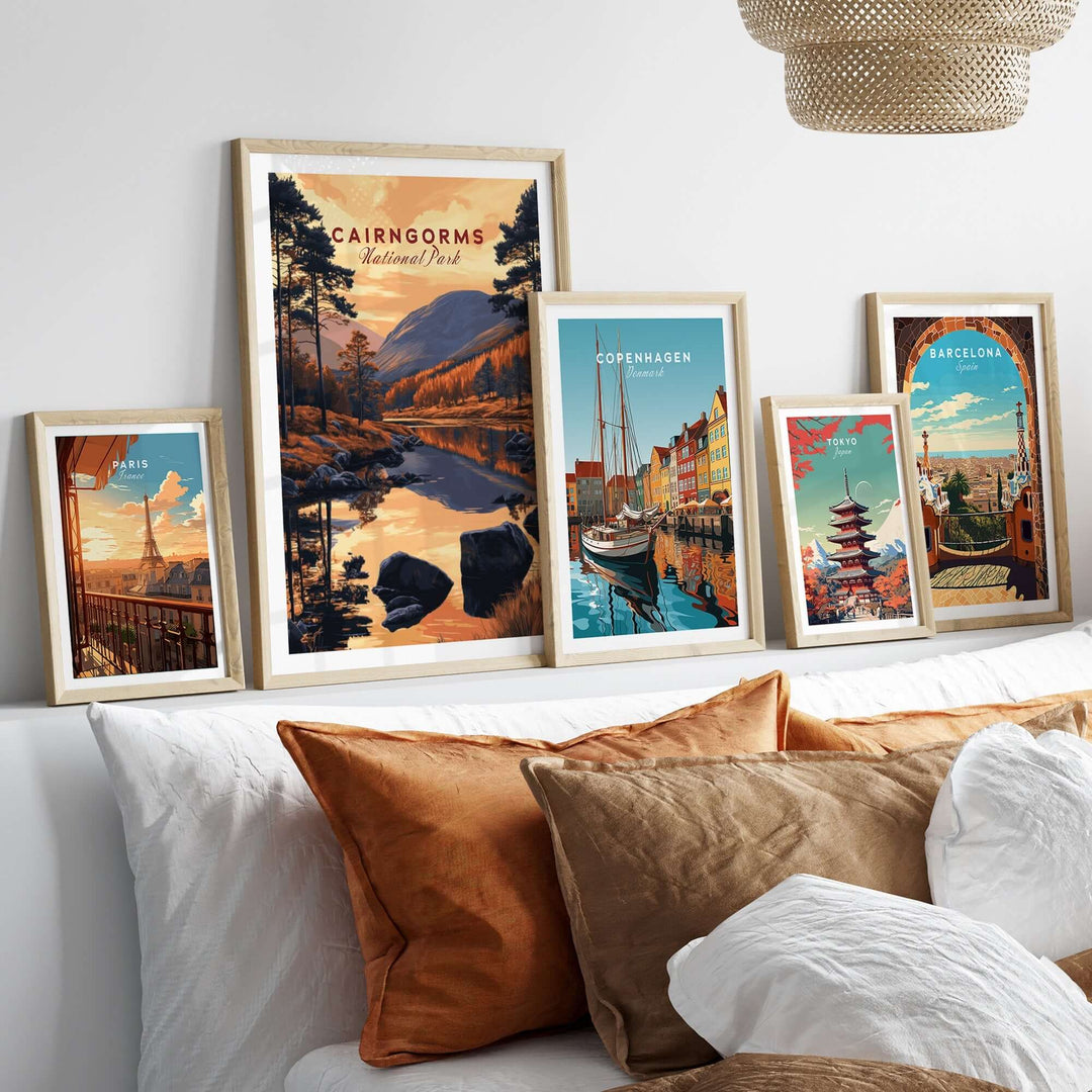 Cairngorms wall art collection displayed above a cozy bed with decorative pillows, featuring vibrant nature and city prints.