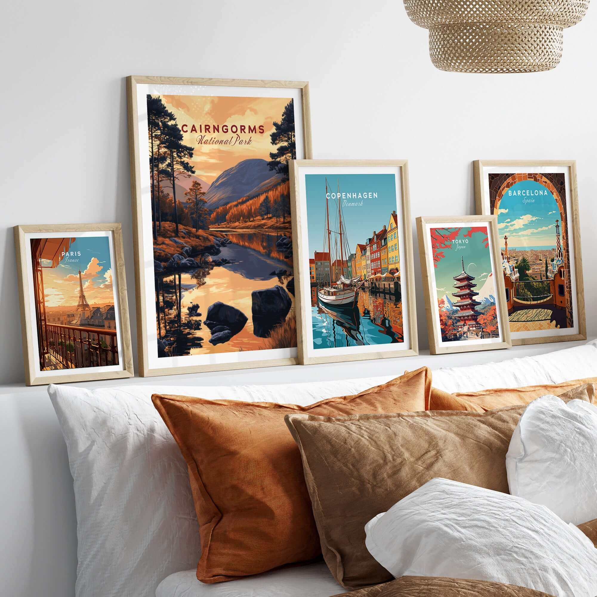 Cairngorms Wall Art and travel-themed artwork displayed on a cozy sofa arrangement.