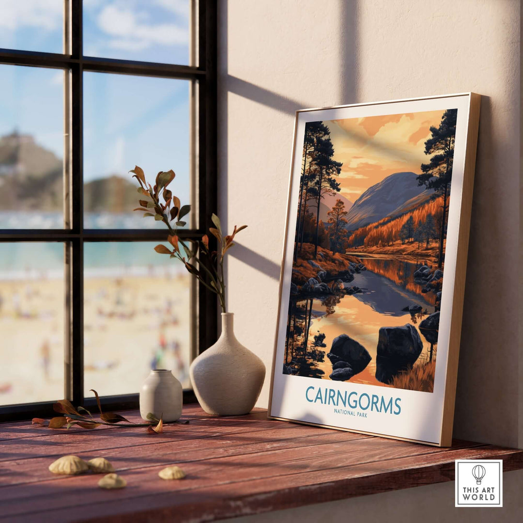 Cairngorms wall art print featuring a scenic view of Scotland, displayed in a cozy interior setting by a window.