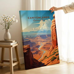 Hand holding Canyonlands National Park travel poster canvas print in a cozy room setting