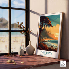 Cape Town poster featuring serene Camps Bay, displayed near a window with beach view, enhancing home decor.