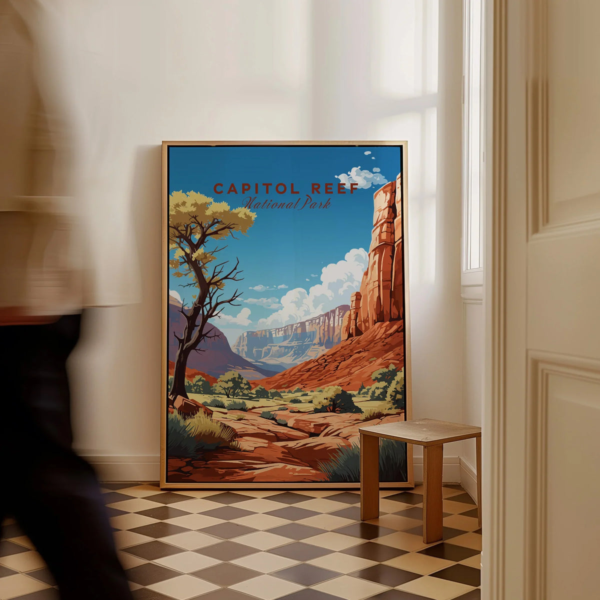 Framed Capitol Reef National Park poster with canyon art on floor in sunlit hallway
