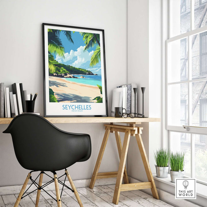 Seychelles beach print on wall in stylish office space with black chair and wooden desk.