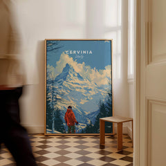 Cervinia Ski Print - Italy framed poster featuring a mountain scene and skier in a cozy interior.
