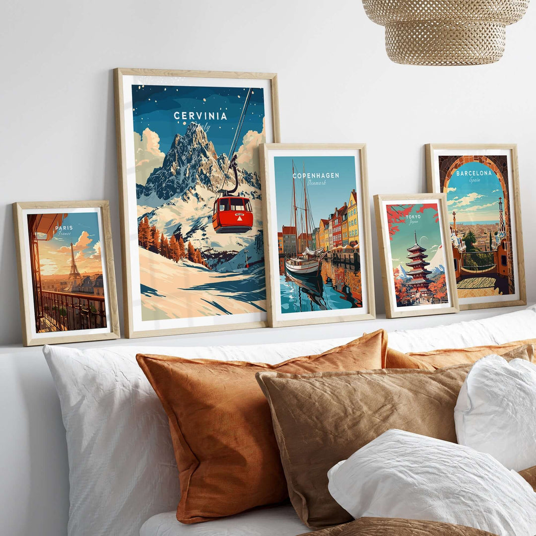 Framed Cervinia Ski Print with vibrant mountain and ski lift, set among other travel artwork on a cozy sofa.