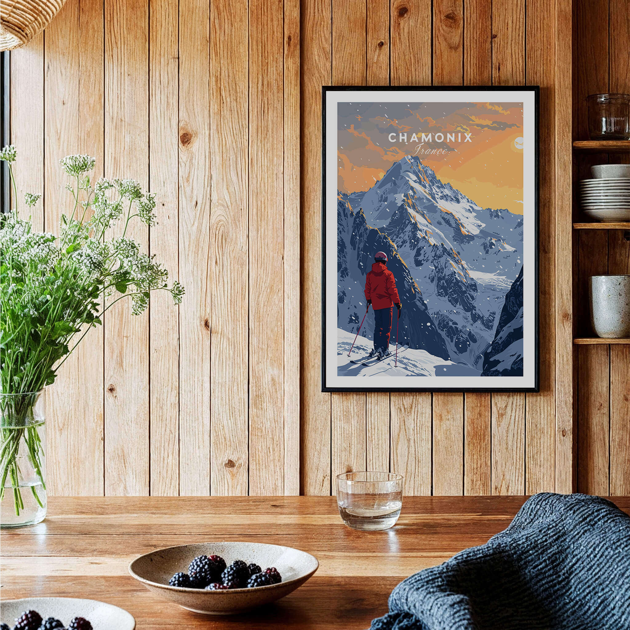 Chamonix Travel Poster - France displayed on a wooden wall, showcasing a scenic mountain view with a skier.