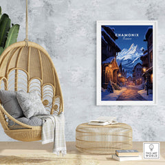 Chamonix poster displayed in a cozy living room with a hanging chair, showcasing a moonlit ski village in France.