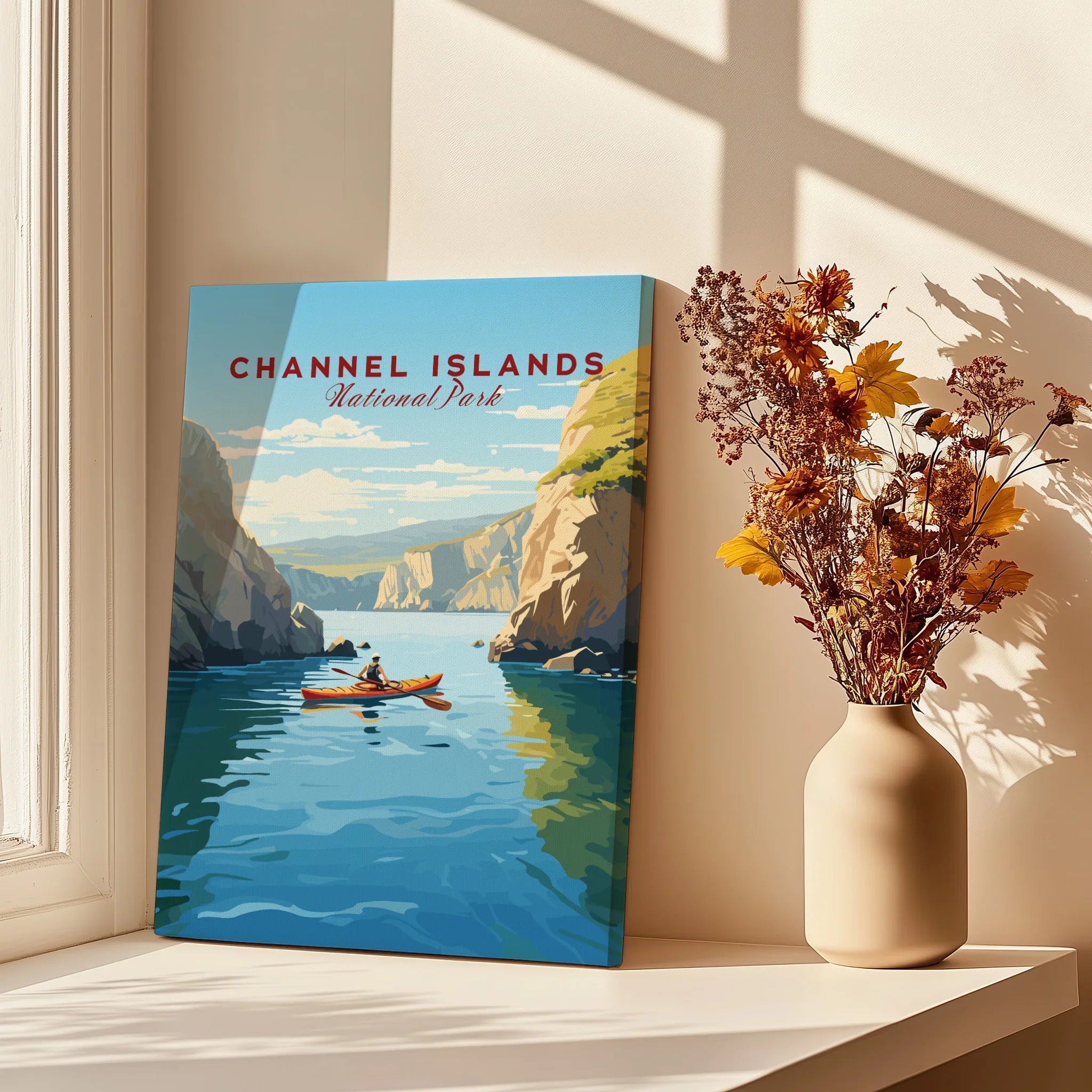 Channel Islands National Park print with a kayaker, set on a sunny windowsill with dried flowers.