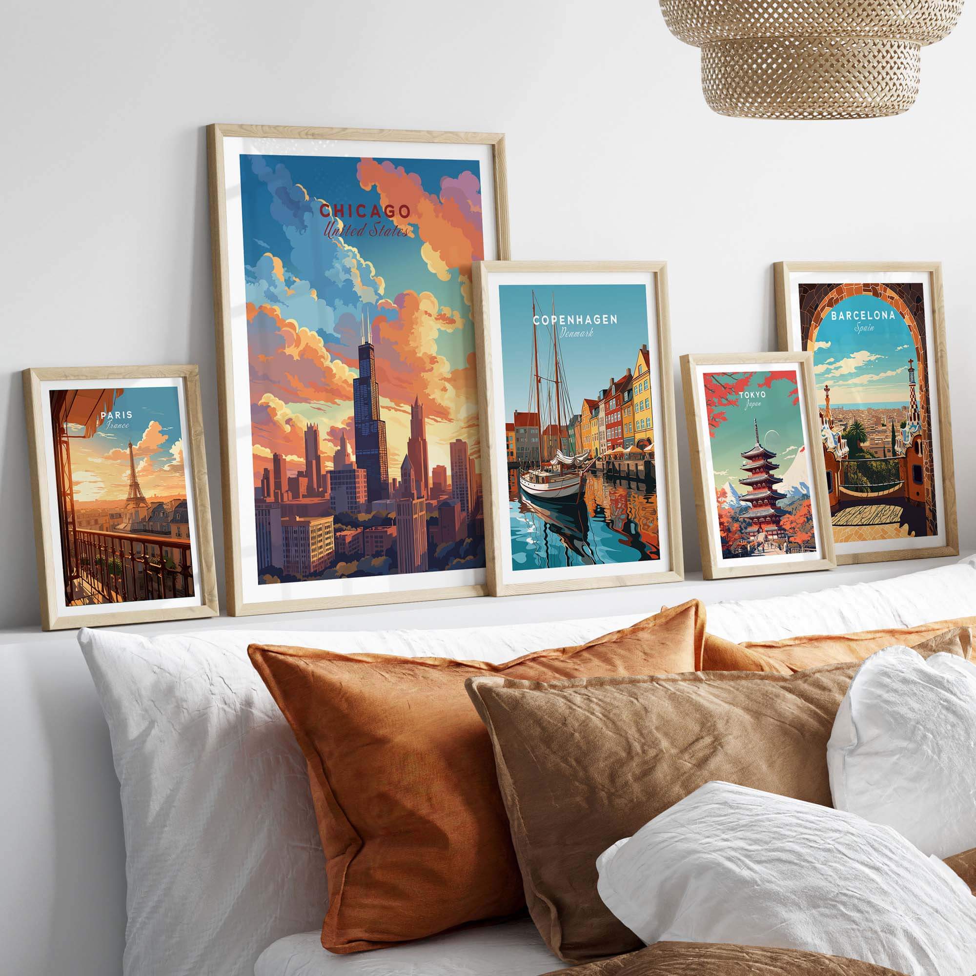 Vibrant Chicago poster alongside travel prints of Copenhagen and Barcelona, decorating a cozy bed with decorative pillows.