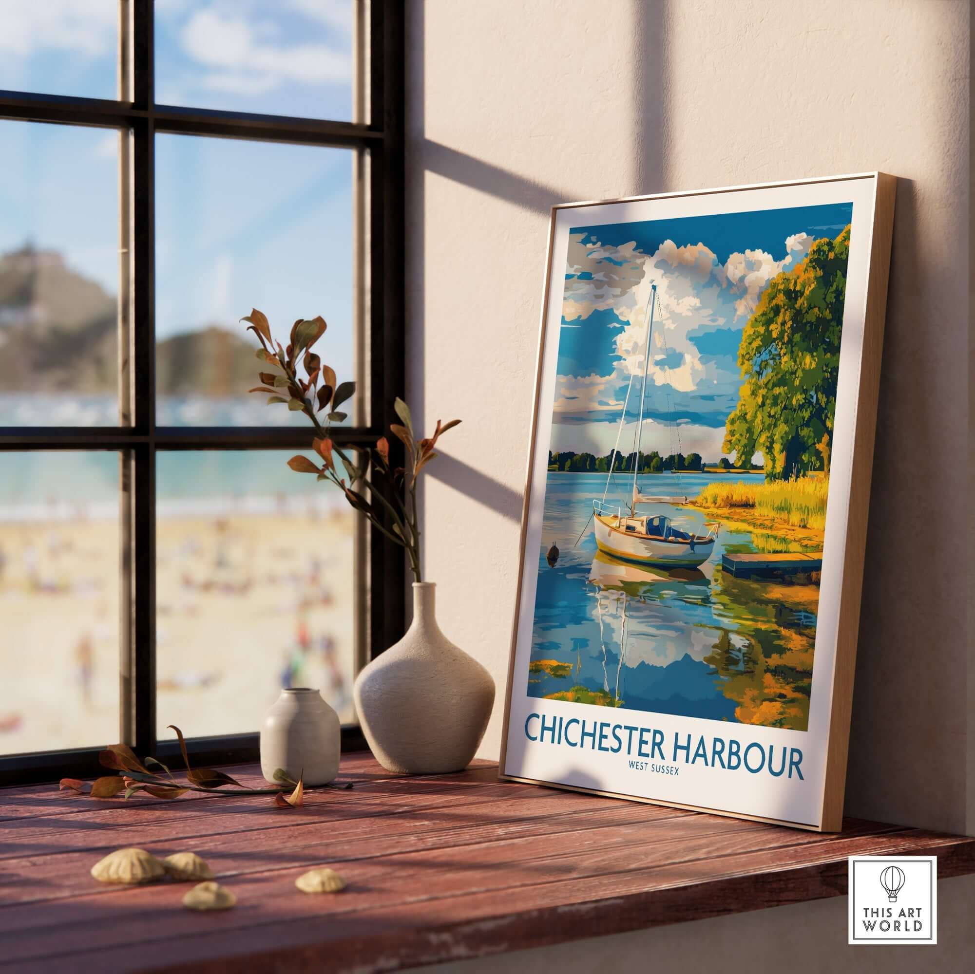 Chichester Harbour Art Print displayed in a sunlit room by a window with a beach view.