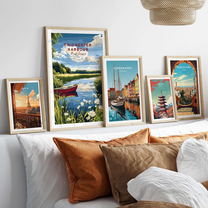 Framed prints of Chichester Harbour and coastal cities displayed in a modern living room setting with decorative pillows.