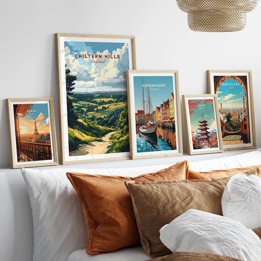 Framed Chiltern Hills art print displayed among other travel-themed prints on a stylish bedroom wall.