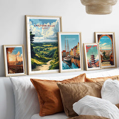 Chiltern Hills Art Print displayed among other framed travel prints on a modern couch backdrop.