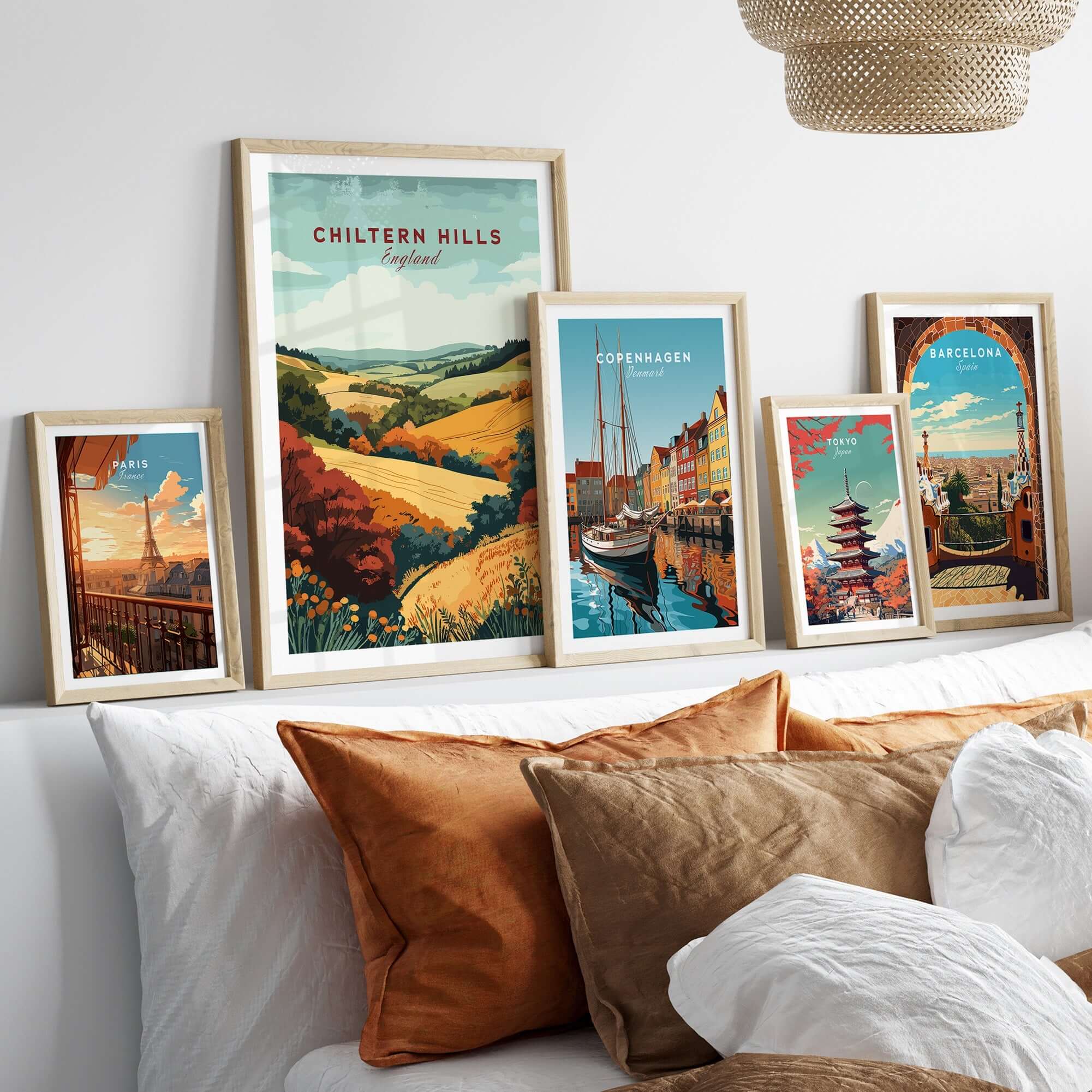 Chiltern Hills Travel Print displayed among other travel prints on a cozy sofa with decorative cushions.