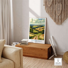 Chiltern Hills Wall Art Print displayed on a wooden table in a cozy living space, showcasing serene hills.