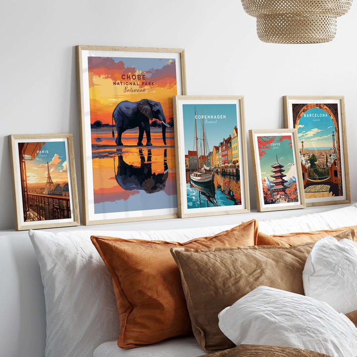 Chobe Elephant digital art print alongside travel posters on a cozy bed, showcasing vibrant decor and wildlife art.