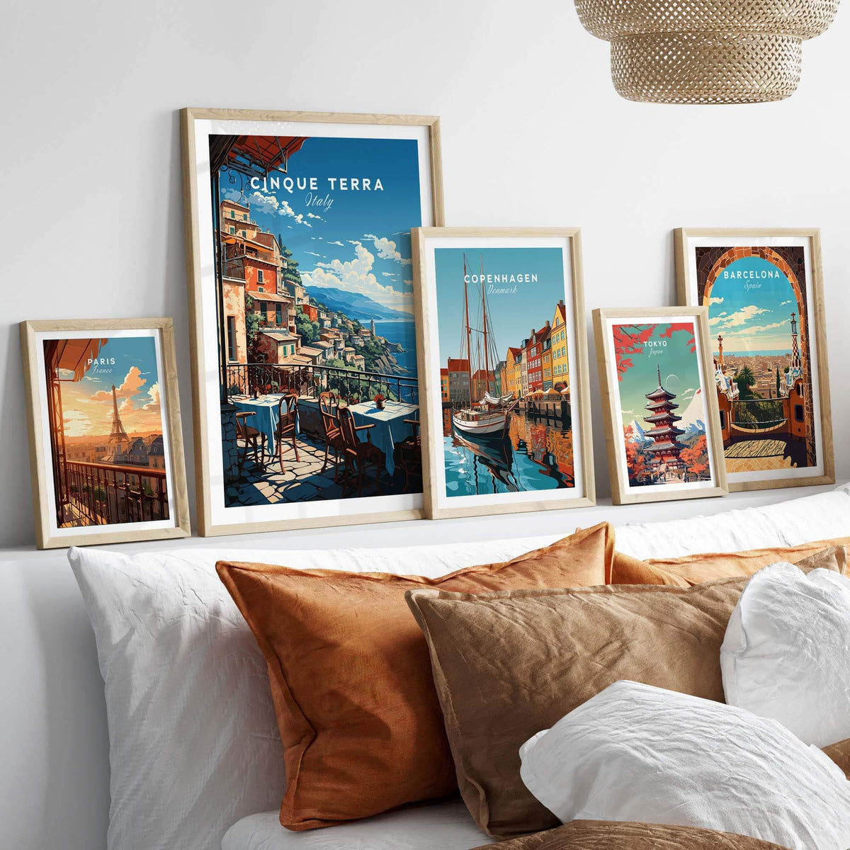 Cinque Terre Poster displayed among other travel posters on a stylish gallery wall with decorative pillows.