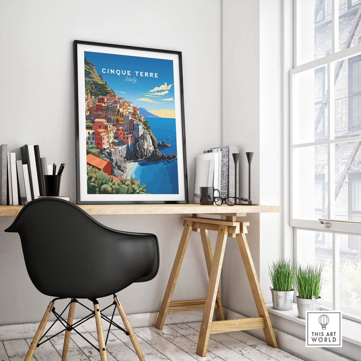 Cinque Terre Travel Poster displayed on a wall in a stylish home office setting, showcasing the Italian Riviera's beauty.
