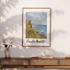 Claude Monet Art Print - Coastal Cliff Path Seascape Wall Art displayed on a wall next to a stylish console table.