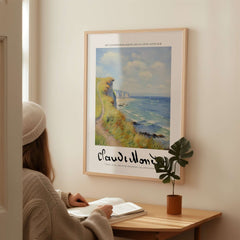 Claude Monet Art Print - Coastal Cliff Path Seascape Wall Art displayed in a cozy room with a woman reading.
