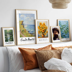 Claude Monet Art Print - Coastal Cliff Path Seascape Wall Art displayed in stylish frames on a bed with decorative pillows.