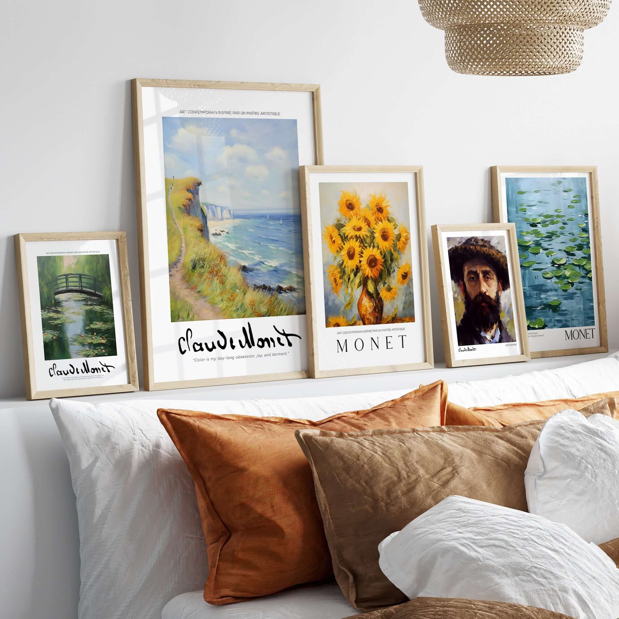 Claude Monet Art Print - Coastal Cliff Path Seascape Wall Art displayed in stylish frames on a bed with decorative pillows.