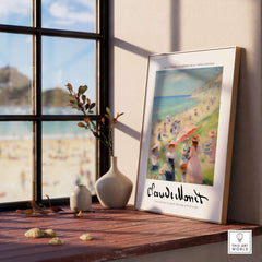Claude Monet Art Print - Elegant Seaside Beach Wall Art displayed on a table with flowers and a beach view.