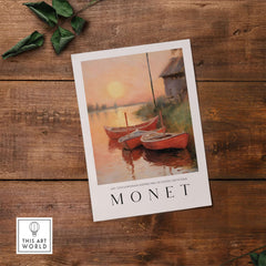 Claude Monet Art Print - Red Boats at Sunset Riverbank Wall Art featuring vibrant boats on a calm river at dusk.