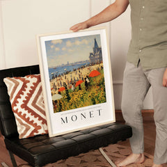 Claude Monet Art Print - Sunny Beach Resort with Flowers Poster displayed indoors, vibrant beach scene with umbrellas.