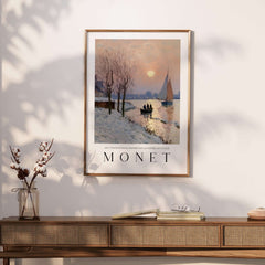 Claude Monet Poster - Winter River Sunset Wall Art - Snow Scene Print displayed on a wall above a wooden console.