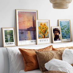 Monet Venice wall art and impressionist prints displayed above a cozy couch with decorative pillows.