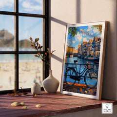 Colourful Amsterdam Architecture Poster - Iconic Canal Houses and Canals Wall Art displayed near a window with a bicycle.