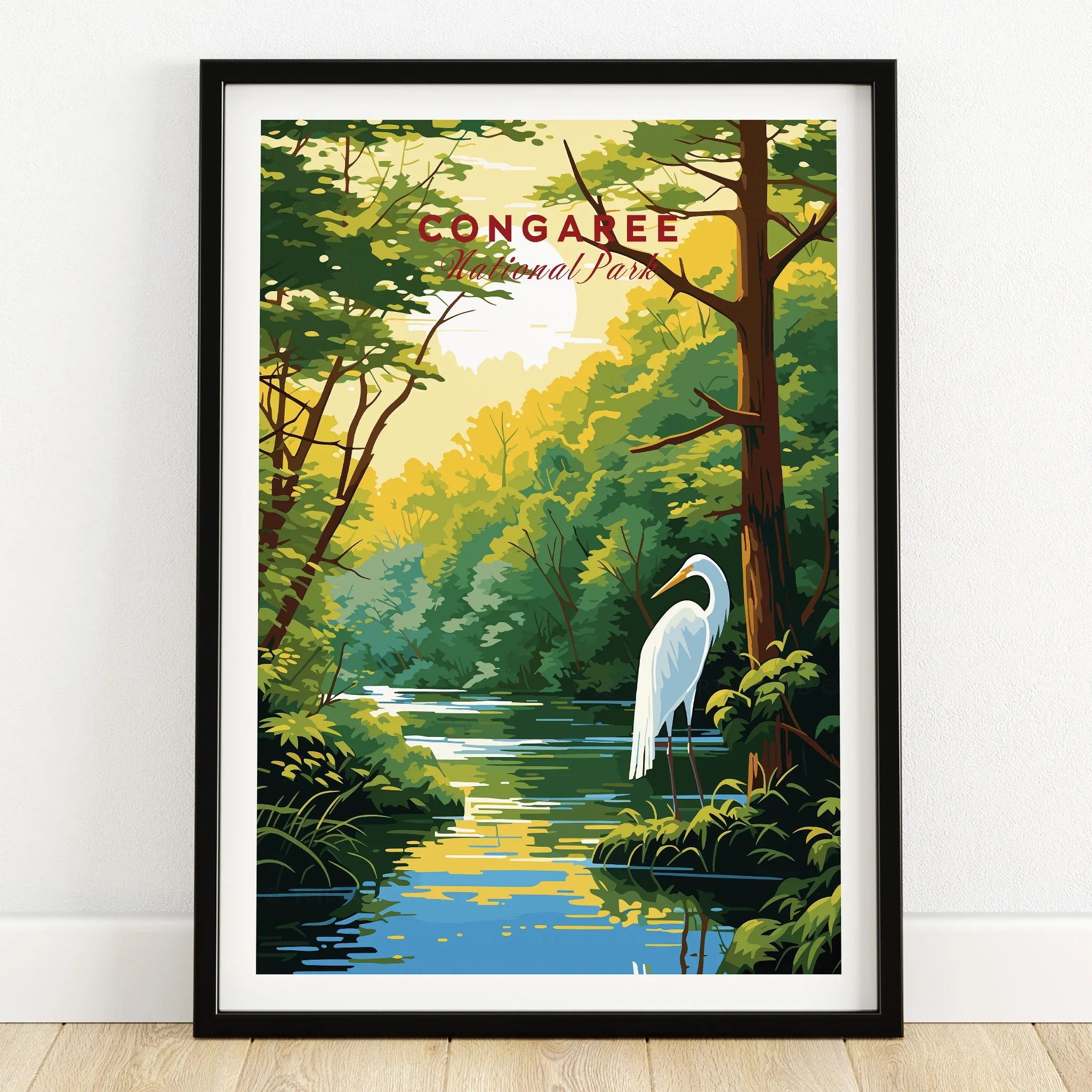 Framed Congaree National Park art print with heron, forest, and river, on wooden floor