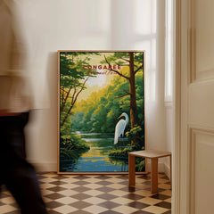 Framed Congaree National Park travel poster with heron, leaning on floor in a sunlit room.