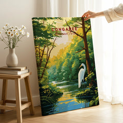Hand holding Congaree National Park travel poster print with heron and forest in bright room