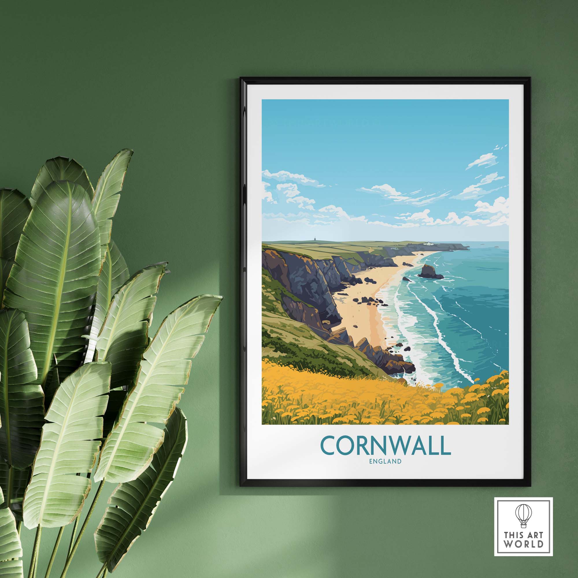 Cornwall poster showcasing stunning seaside views, framed on a green wall with lush plants nearby.