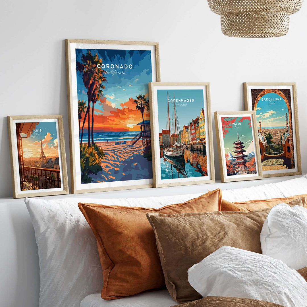 Multiple framed art prints featuring Coronado, Copenhagen, and Barcelona displayed on a stylish bed with decorative pillows.