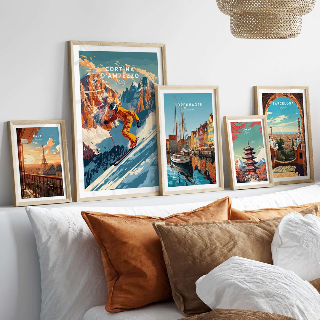 Cortina d'Ampezzo ski poster displayed among framed art on a cozy bed with cushions in a stylish interior setting.