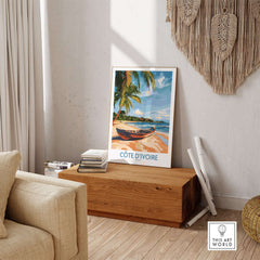 Côte d'Ivoire Travel Print featuring a serene beach scene with palm trees and a boat, ideal for home decor.