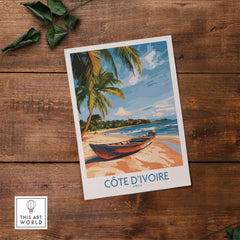 Côte d'Ivoire Travel Print featuring a serene beach scene with palm trees and a canoe on the sand.