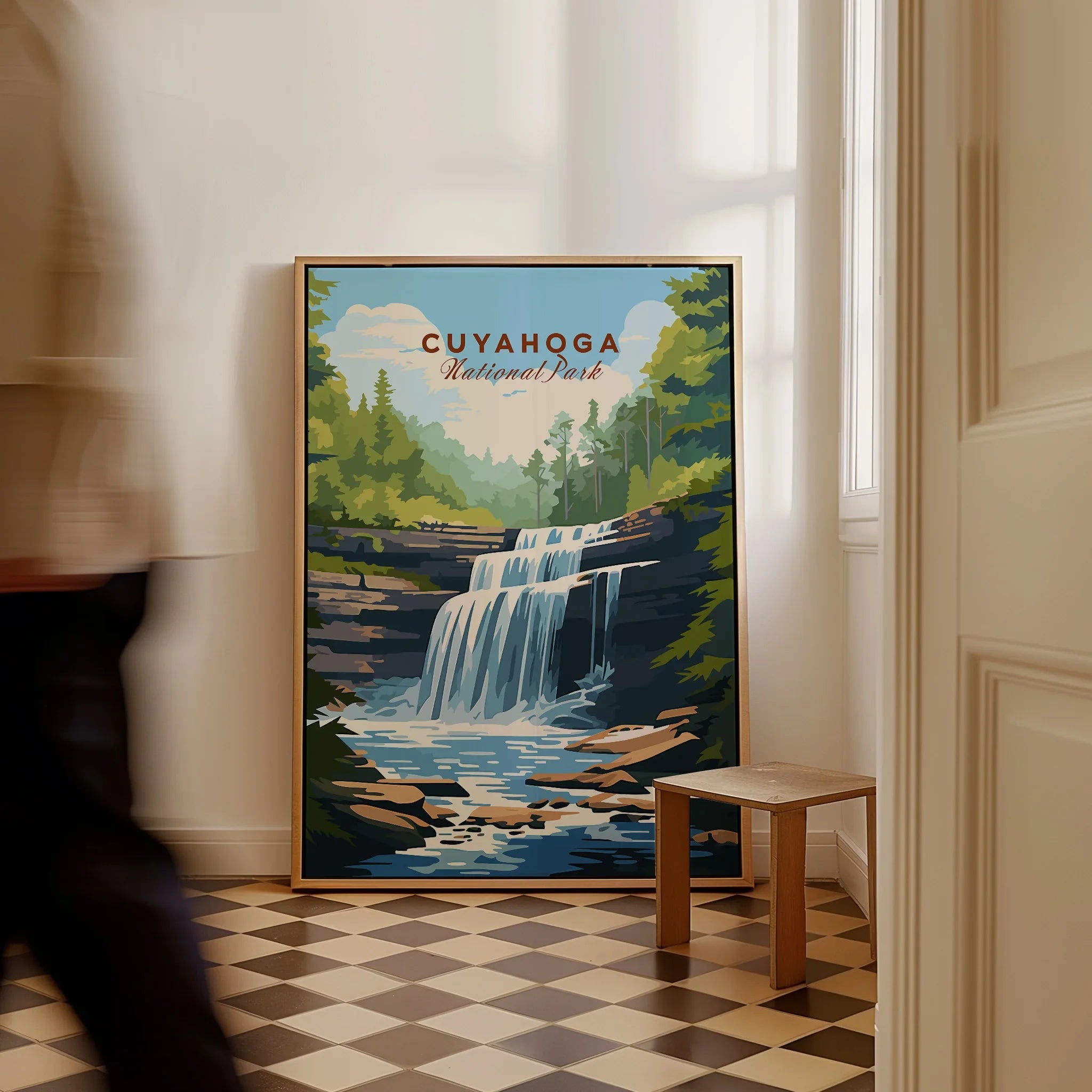 Cuyahoga National Park travel poster framed, leaning on floor by a window, man walking past