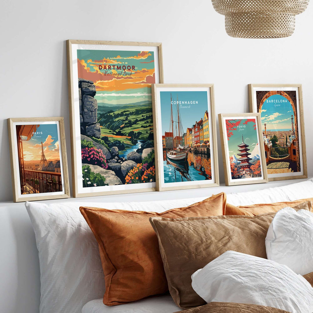 Dartmoor National Park print displayed among other city prints on a stylish wall above a cozy bed with decorative pillows.