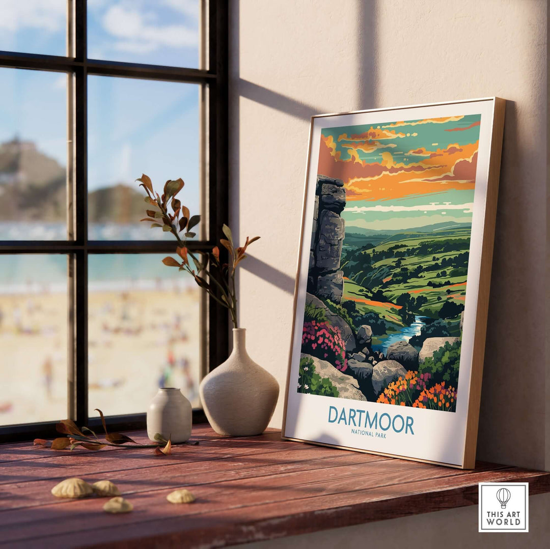 Dartmoor National Park print displayed on a wooden table, highlighting colorful landscapes and artistic design next to a window.